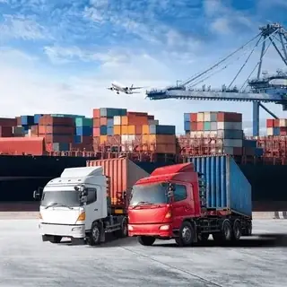 Container trucks at a port with cranes and a cargo plane overhead